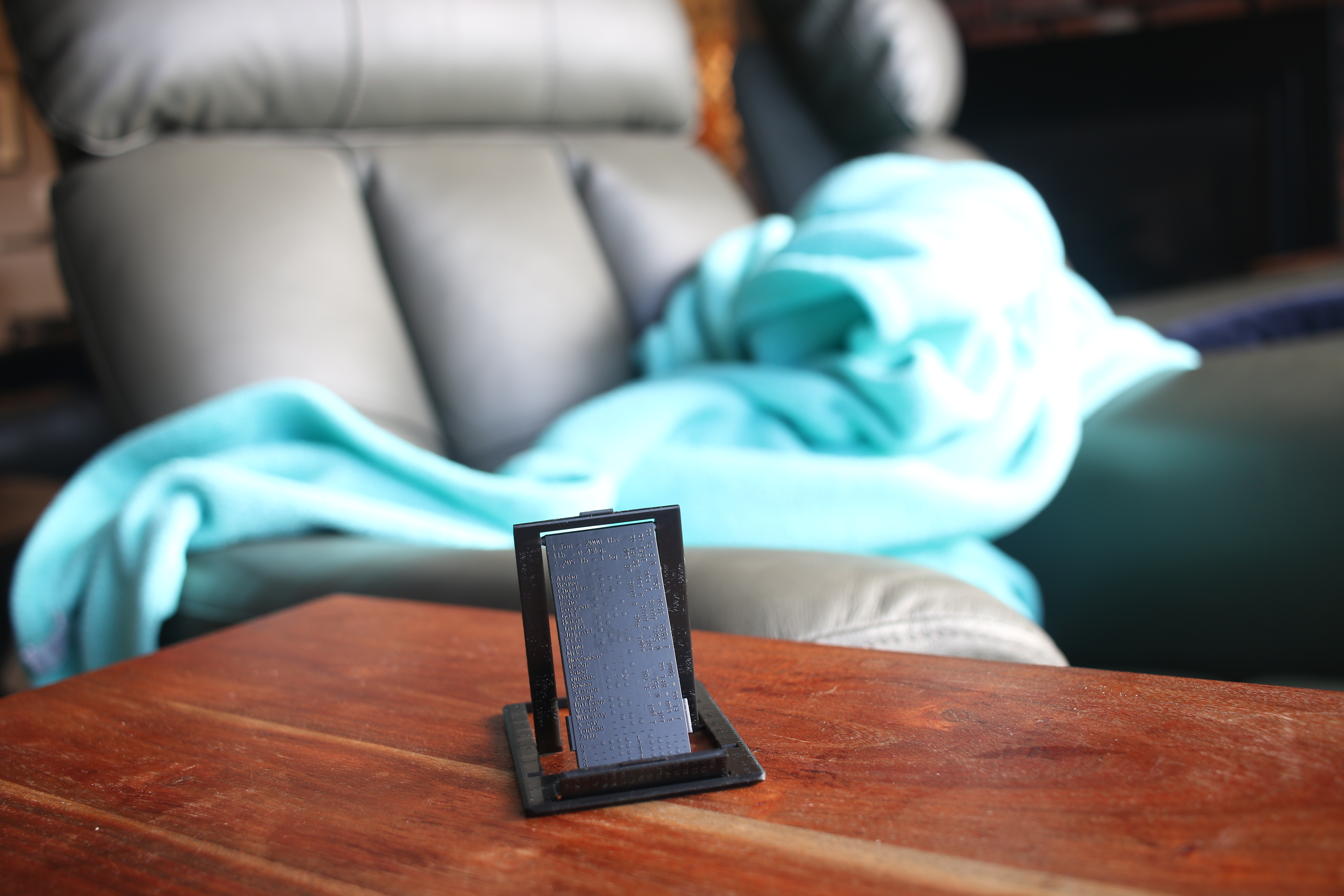 Wallet sized phone stand, WalletStand, on end table.